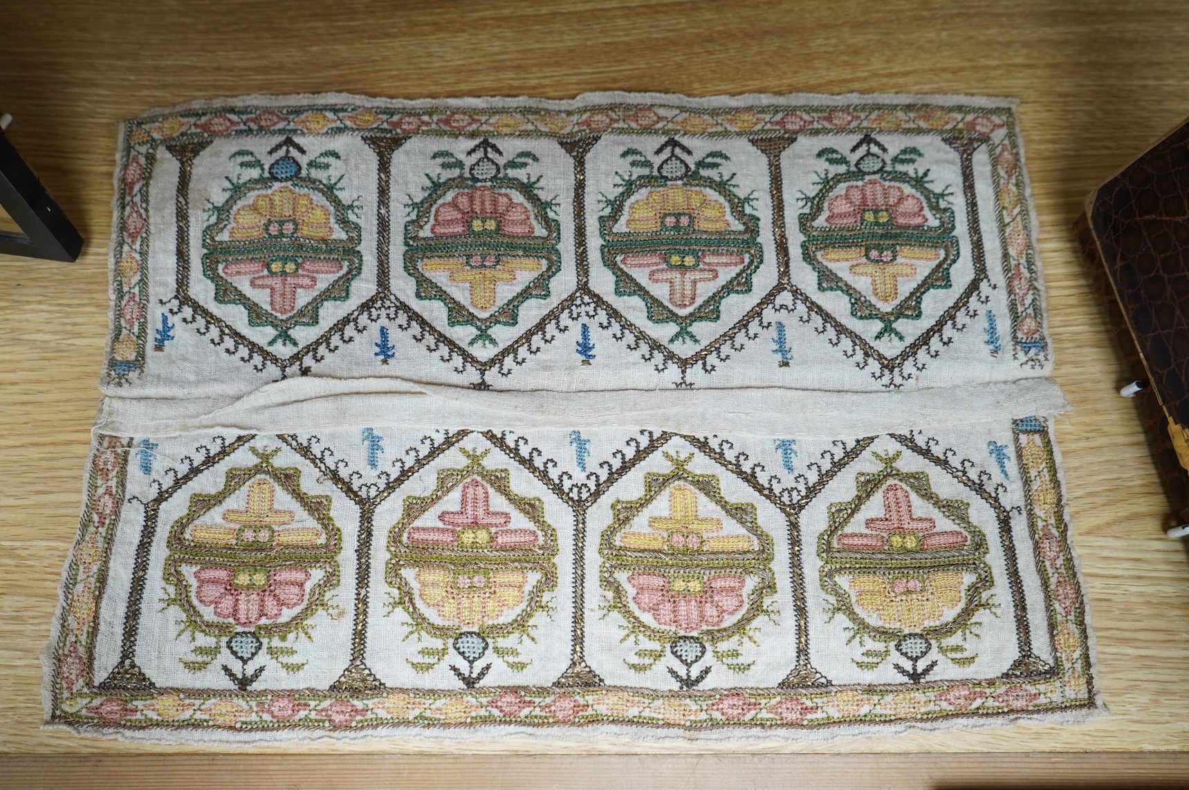 Two 19th century Turkish hand embroidered towel ends sewn together later as a table centre. Worked on fine hand woven linen in polychrome silks with gold metallic thread fillings, 39.5cm wide x 26.5cm deep. Condition - t